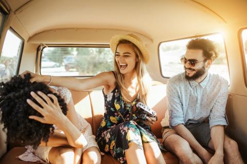 Three people in the back of a car